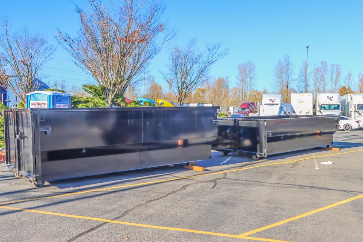 Professional dumpster rental service with roll-off container on residential driveway in Covina